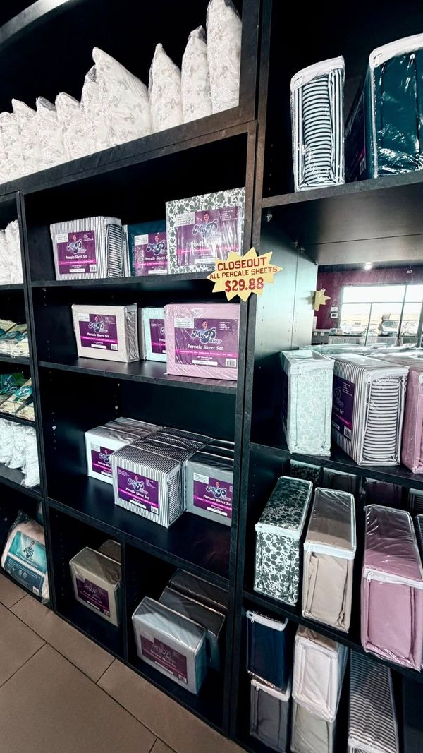 Shelves of neatly folded bedding and pillow packaging