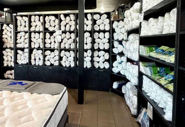 Rolled towels and bedding on store shelves